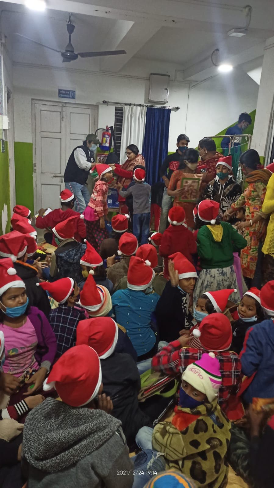 Mrs Keya Basak distributing Christmas gifts among children